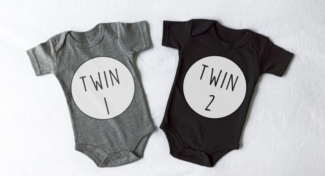 Two onesies with Twin 1 and Twin 2 on the front
