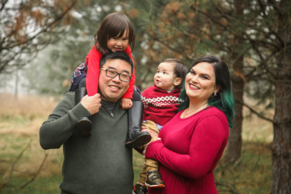 the Wong family holiday photo in the forest looking happy