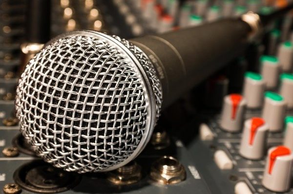 Close up image of a microphone on a mixer