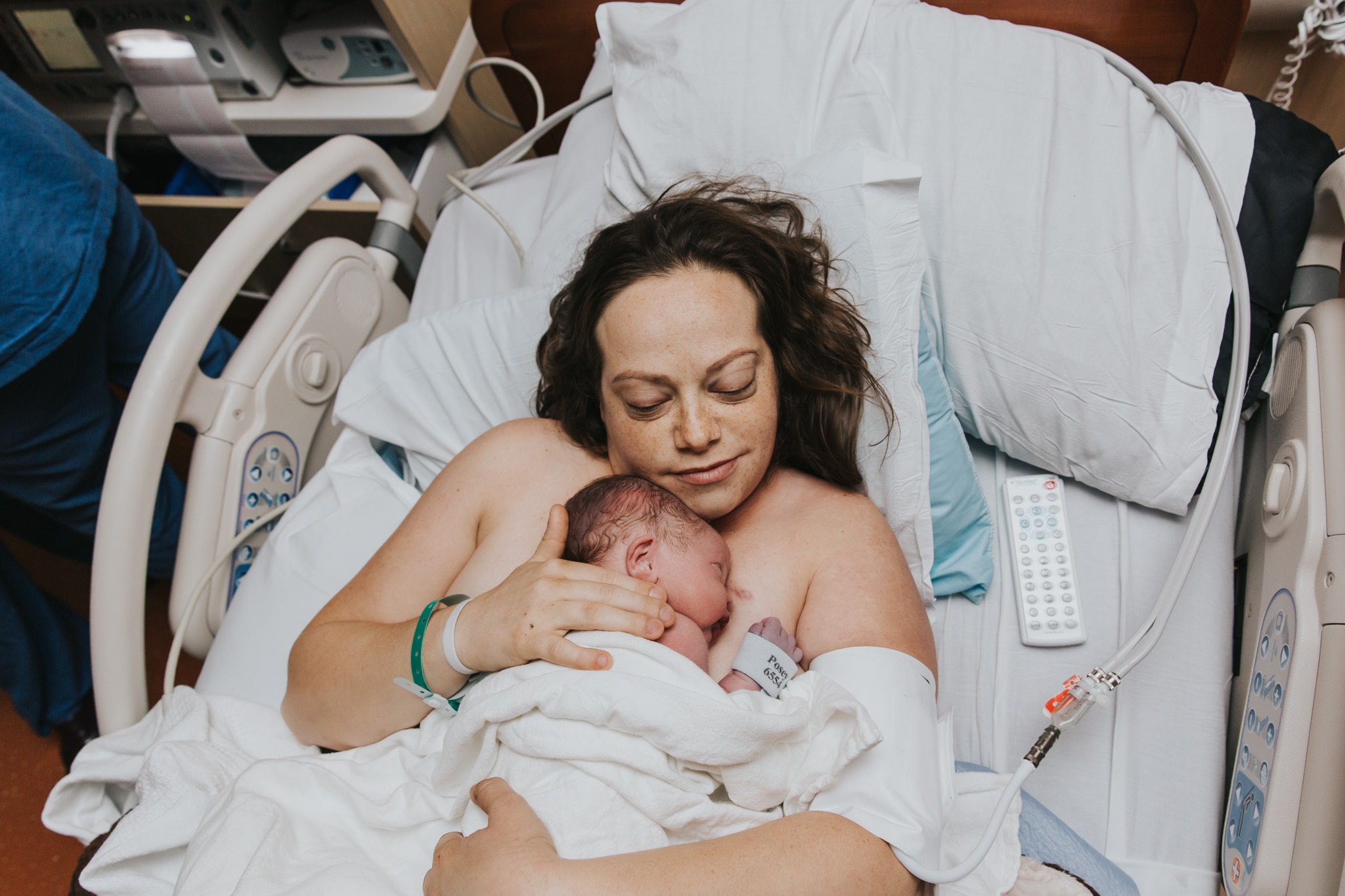 Breast Cancer Survivor holds her just born miracle baby against her chest