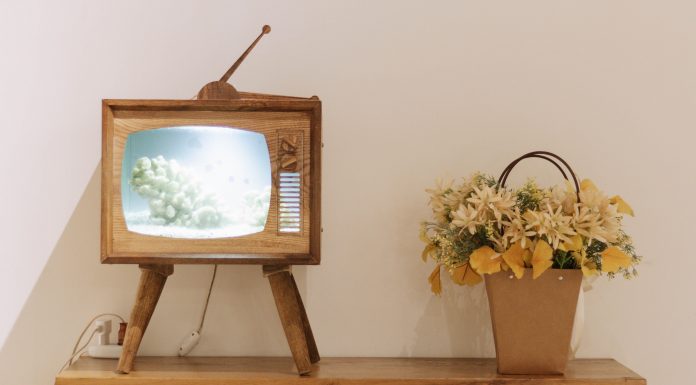 vintage tv on stand with yellow flowers