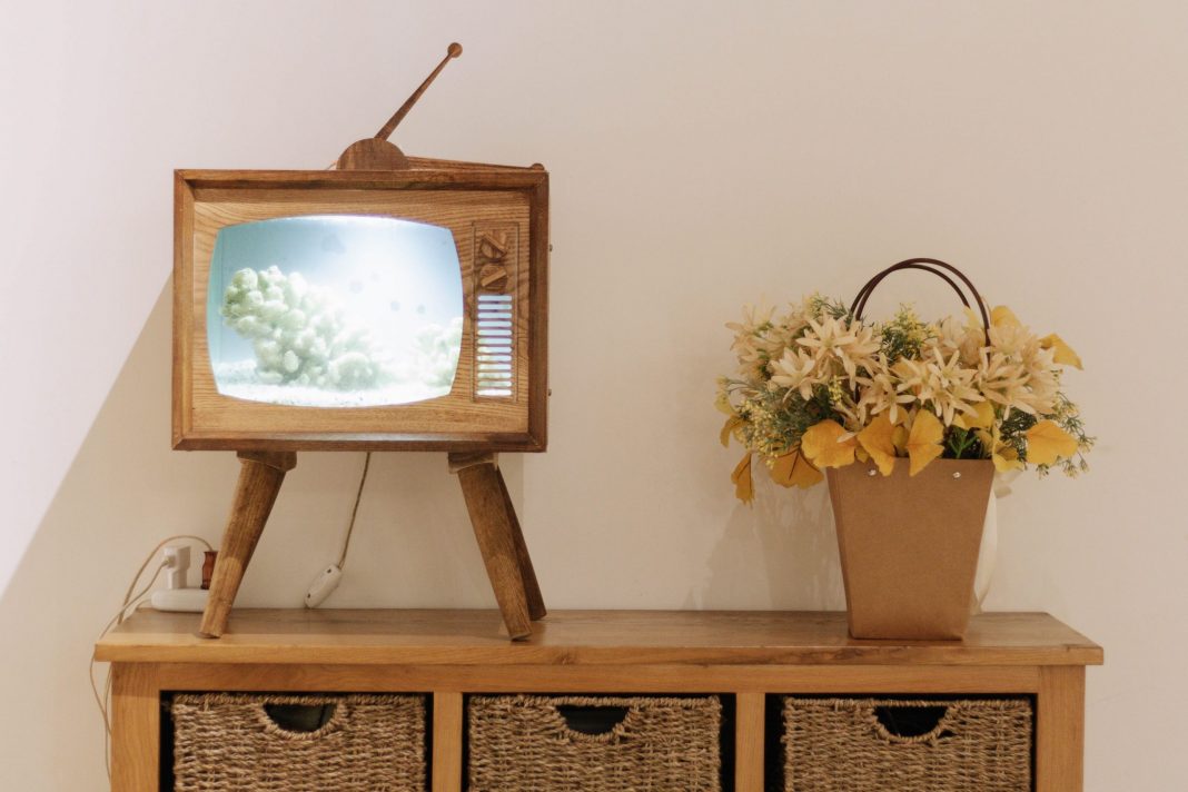 vintage tv on stand with yellow flowers