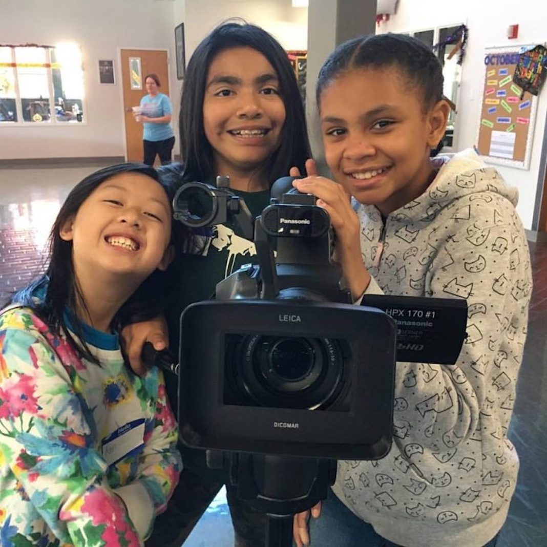 Future Filmmakers: Three kids stand around a camera