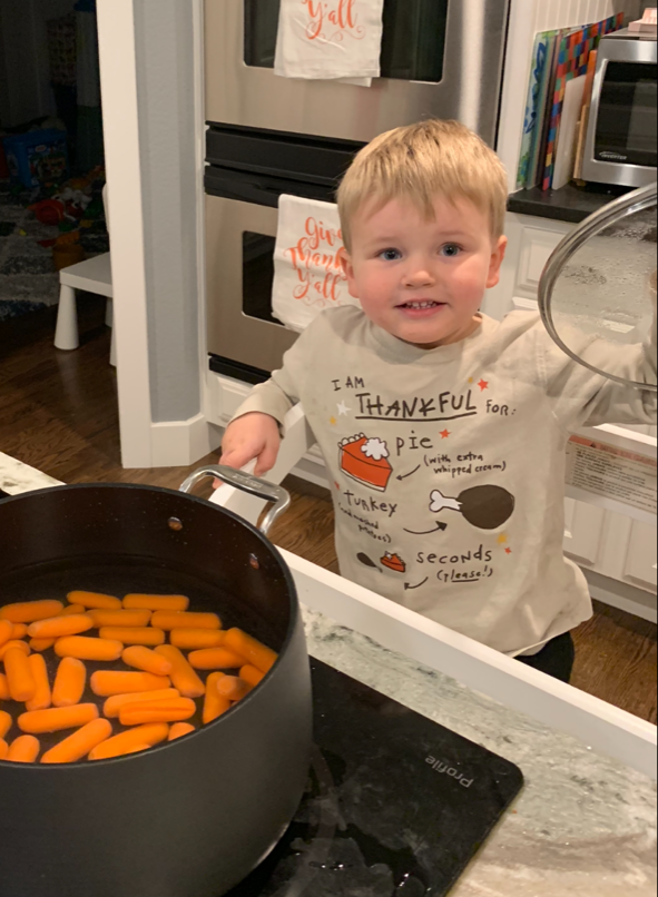 Child makes carrot shuffle on stovetop