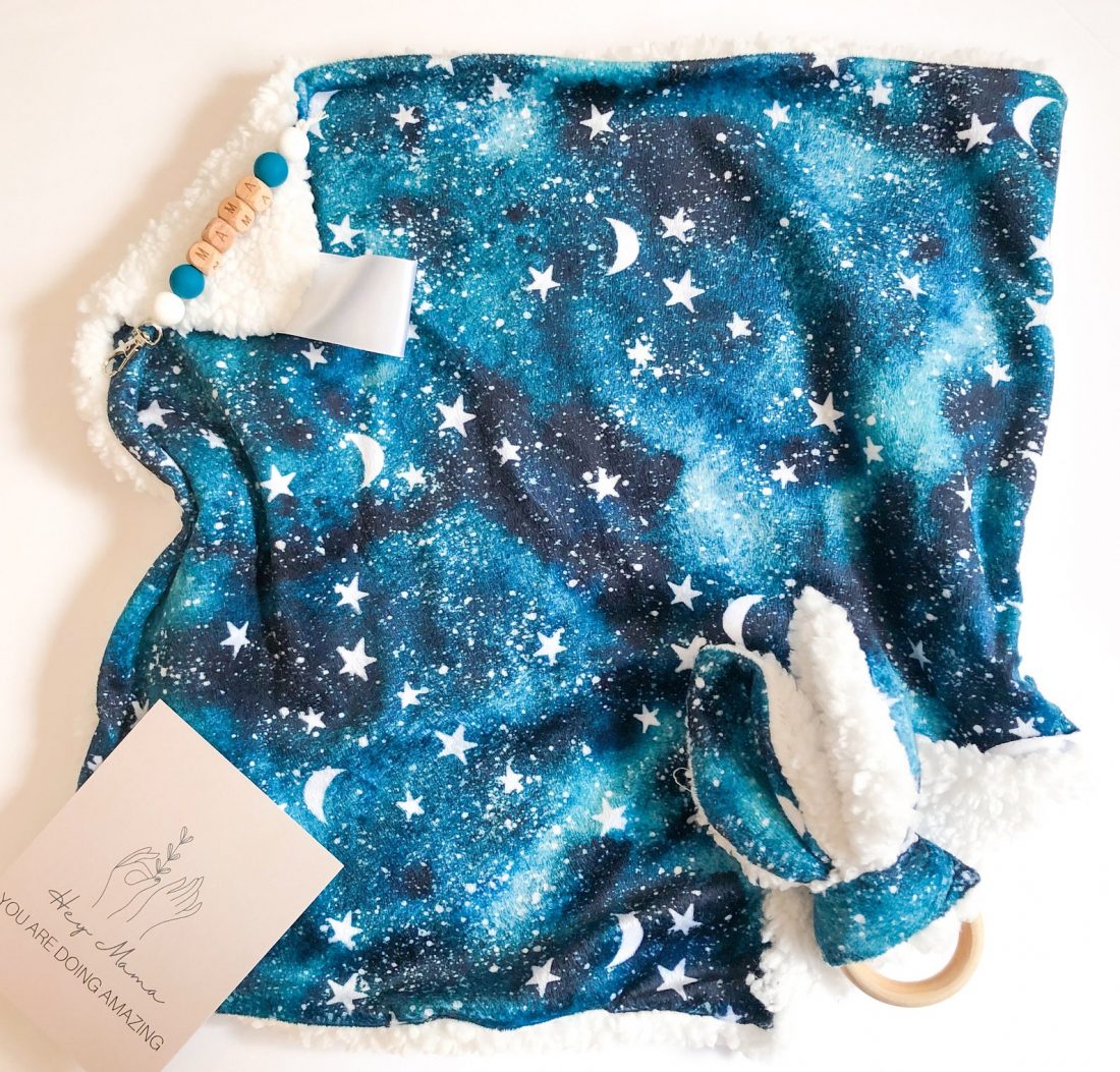 Lovely blanket from Little Wildlings Store that features a black and blue ski with white moons and stars
