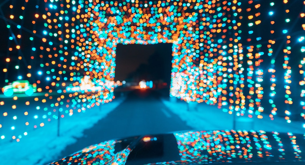 Archway of holiday lights as taken from inside a car