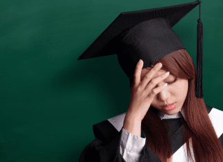 Sad girl in graduates robe and cap