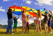 Kids playing in a field with a flag