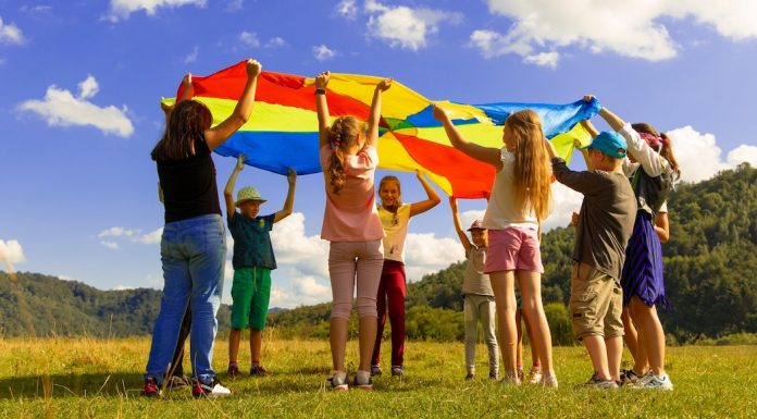 Kids playing in a field with a flag