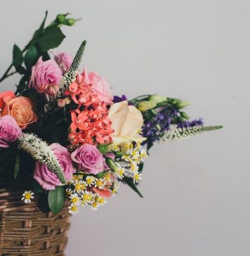 Bouquet of flowers sitting in a wicker basket