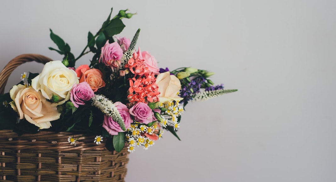 Bouquet of flowers sitting in a wicker basket