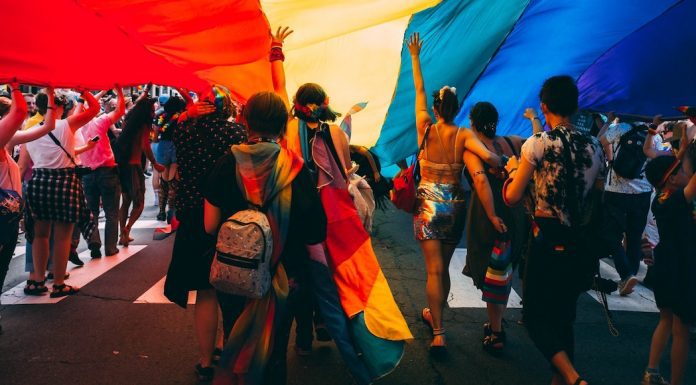 Pride Festival Flag with people dancing under it