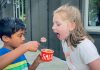 Boy feeding girl ice cream