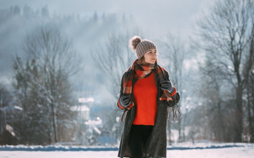 Image of woman in warm clothing outside on a cold winter day.