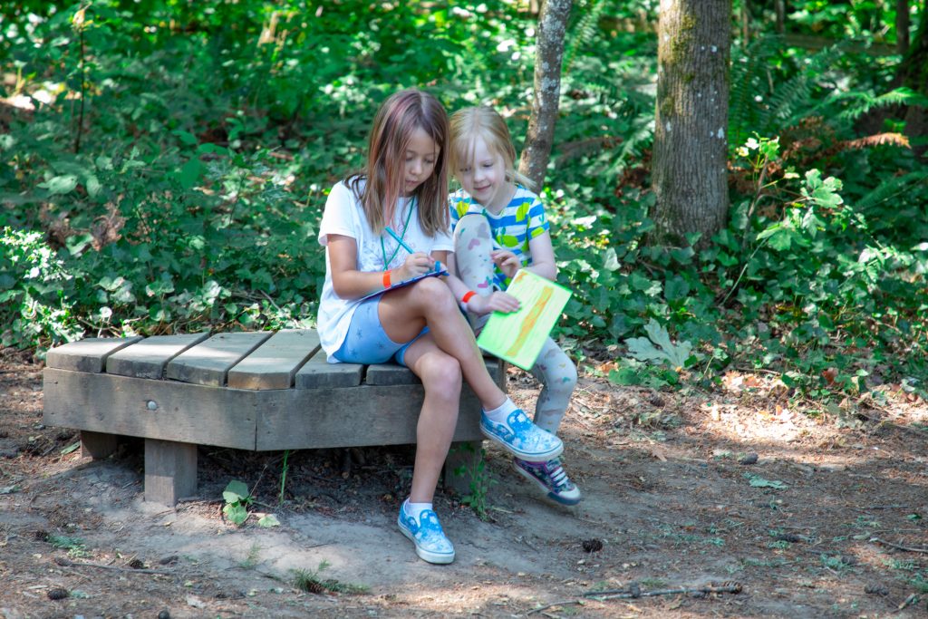 Image of two young campers enjoying OES summer camp fun.